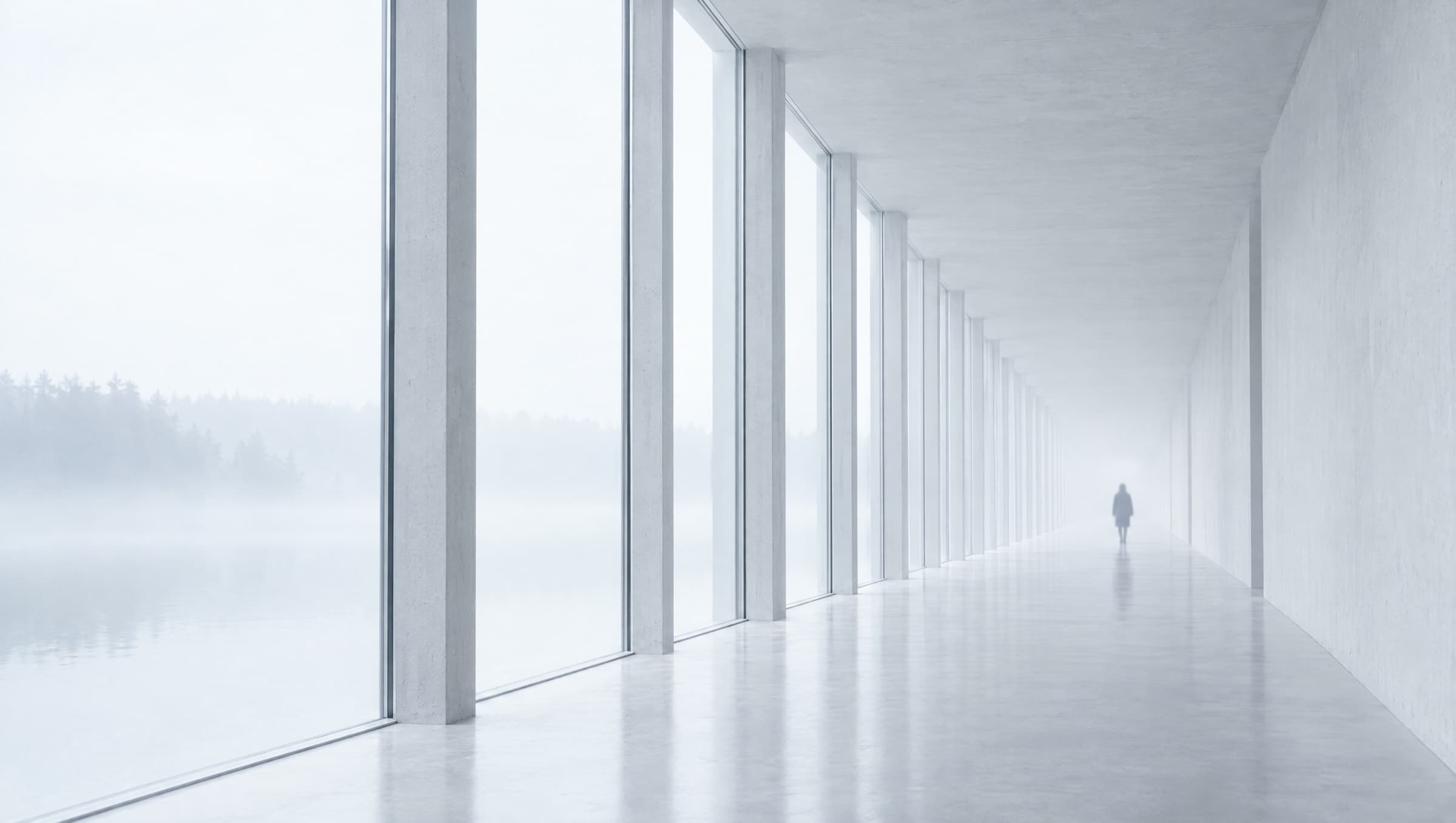 A long concrete corridor with evenly spaced windows