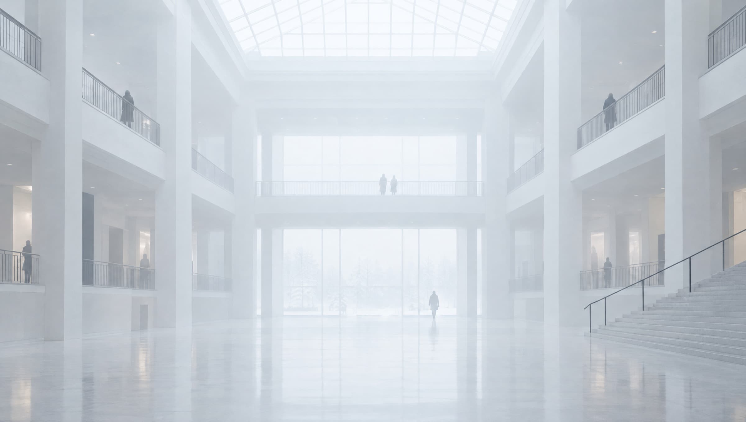 A symmetrical white atrium filled with soft haze